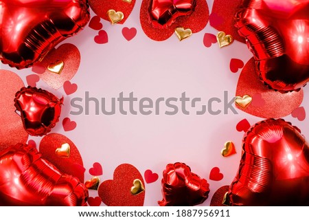 Text frame with red and gold hearts foil balloons top view on pink Valentine's Day background. Copyspace.