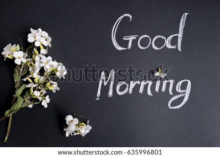 Text Good morning white flowers on a black background