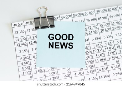 the text of Good News on a blue card clip to a sheet of paper on a light desk, business concept