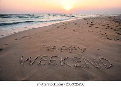 Text Happy Weekend written on sandy beach at sunset - Powered by Shutterstock