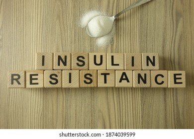 Text insulin resistance from wooden blocks with spoon of sugar, diabetic concept - Shutterstock ID 1874039599