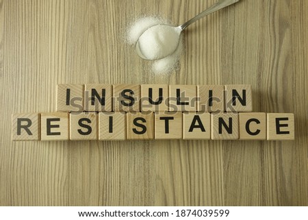 Text insulin resistance from wooden blocks with spoon of sugar, diabetic concept