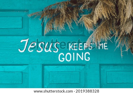 Text Jesus keep me going on a wooden turquoise background. Religious poster
