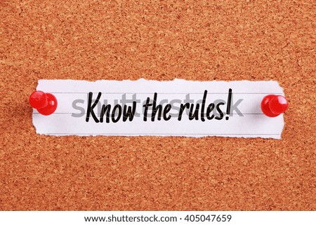 Text Know The Rules written on note paper pinned on the corkboard.