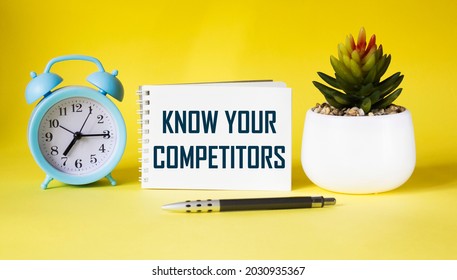 The text know your competitors is written on a notebook, an image of a business concept on a yellow background with a cactus, a clock and a pen