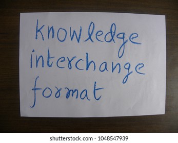 Text Knowledge Interchange Format Hand Written By Blue Oil Pastel On White Color Paper