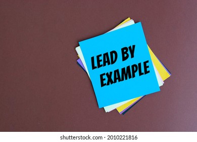 Text lead by example on the short note texture background