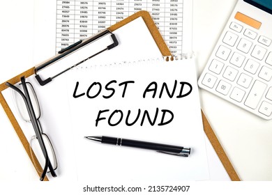 Text LOST AND FOUND On The White Paper On A Clipboard With Chart And Calculator