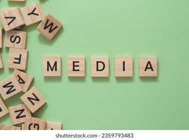 Text media on wooden cubes on green background