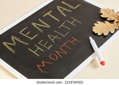 Text Mental Health Month On A Black Plate And Autumn Oak Leaves, Helping People With Mental Problems Concept, October