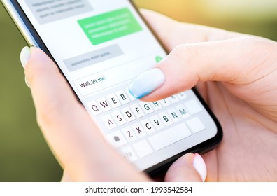Text message with mobile phone. Woman texting sms with smartphone Catfish or digital scam. Screen keyboard in instant messaging chat. Macro close up of finger writing. Conversation with boyfriend. - Shutterstock ID 1993542584