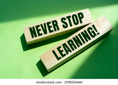 Text Never Stop Learning on a wooden blocks. Education concept.