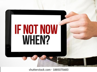 Text if not now, when on tablet display in businessman hands on the white bakcground. Business concept
