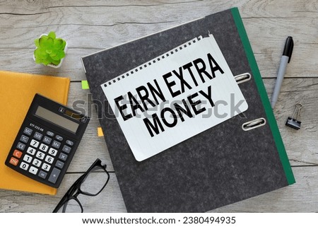 text in notepad in a folder. near a yellow notepad with a calculator: Earn Extra Money