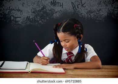 Text On Black Chalkboard Against Schoolgirl Doing Her Homework Against Chalkboard