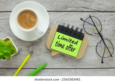 text on a bright green sticker near the glasses on the work desk.. Limited time offer. - Powered by Shutterstock