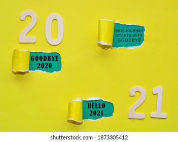 Text on colorful torn paper with Year 2021 background. New journey starts with goodbye, goodbye 2020 and hello 2021. Happy New Year Concept