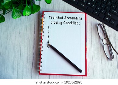 Text On Notebook With Glasses, Pen, Keyboard And Green Plant On The Table - Year End Accounting Closing Checklist