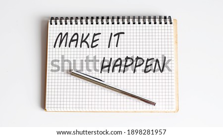 Text on notepad MAKE IT HAPPEN on white background. Business