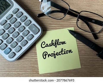 Text on notepad with pen, calculator, glasses and calculator - Cashflow Projection