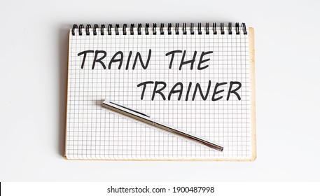 Text On Notepad Train The Trainer On The White Background. Business Concept