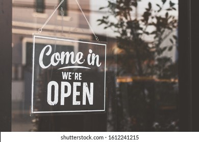 Text on vintage black sign "Come in we're open" in cafe. - Shutterstock ID 1612241215