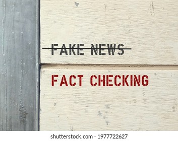 Text on wall FAKE NEWS (cross out) FACT CHECKING ,concept of protection from made-up stuff which easily viral spread online , fact checking is a must before sharing