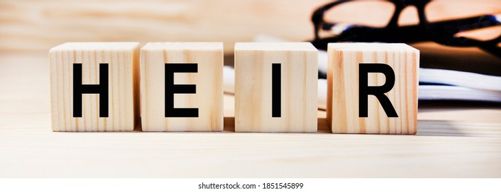 Text on wooden heir cubes, glasses and reports in the background. - Shutterstock ID 1851545899