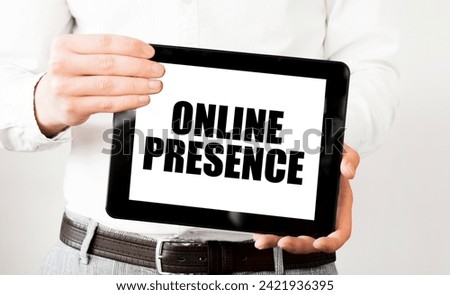 Text ONLINE PRESENCE on tablet display in businessman hands on the white background. Business concept