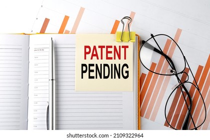 Text PATENT PENDING on sticker on notepad on diagram background
