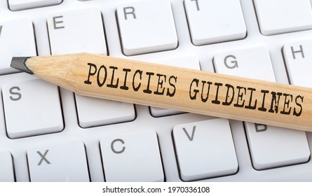 Text POLICIES GUIDELINES On Wooden Pencil On White Keyboard. Business