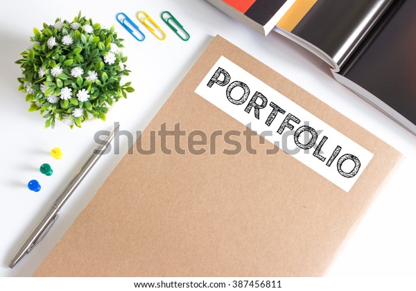Text Portfolio on brown paper book on table /
business concept