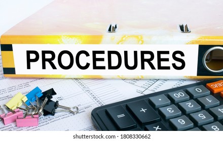 Text Procedures on the folder that is located on the financial reports with calculator and stationery clips. Business and financial concept