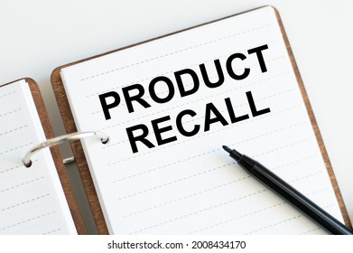 Text Product Recall On An Open Notebook On A White Background.