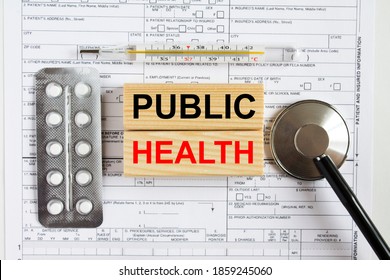 Text Public Health On Jenga Cubes With A Stethoscope And Pills Are On Medical Documents. Medical Concept Photo