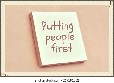 Text Putting People First On The Short Note Texture Background