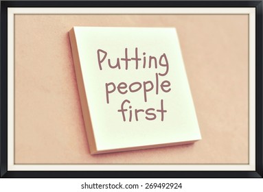 Text Putting People First On The Short Note Texture Background