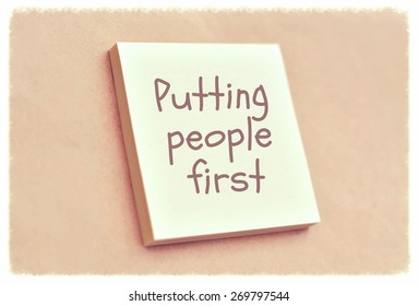 Text Putting People First On The Short Note Texture Background