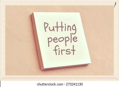 Text Putting People First On The Short Note Texture Background