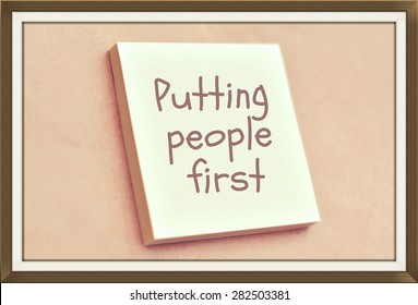 Text Putting People First On The Short Note Texture Background