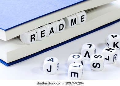 Text reading READ ME between pages of book