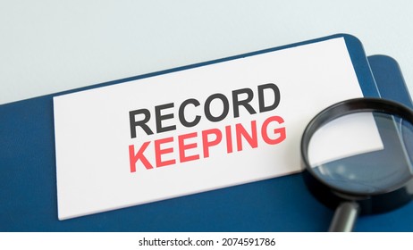 text record keeping on white paper card, black ahd red letters. lens on blue background. business concept. education concept. - Shutterstock ID 2074591786
