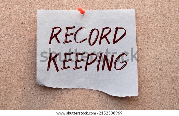 text record keeping on white paper card, black
ahd red letters. lens on blue background. business concept.
education concept.