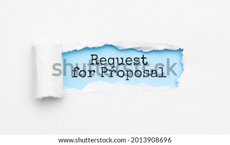 The text Request for Proposal appearing behind torn yellow paper