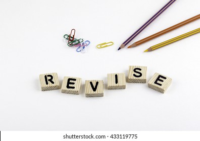 Text: Revise From Wooden Letterson On White Office Desk