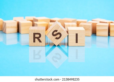 the text RSI - Relative Strength Index - written on the wooden cubes in black letters, the cubes are located on a bright blue glass surface. concept word forming with cubes on background .