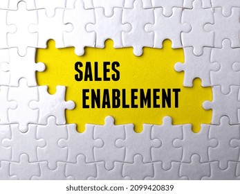 Text SALES ENABLEMENT written on yellow background with white puzzle. - Shutterstock ID 2099420839