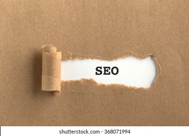 The text SEO behind torn brown paper