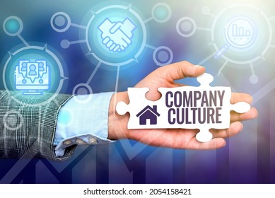 Text Showing Inspiration Company Culture. Business Approach The Environment And Elements In Which Employees Work Hand Holding Jigsaw Puzzle Piece Unlocking New Futuristic Technologies.