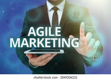 Text Sign Showing Agile Marketing. Conceptual Photo Focusing Team Efforts That Deliver Value To The Endcustomer Man In Office Uniform Standing Pressing Virtual Button Holding Tablet.